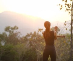 Rear,view,healthy,young,woman,stretching,in,the,park,before