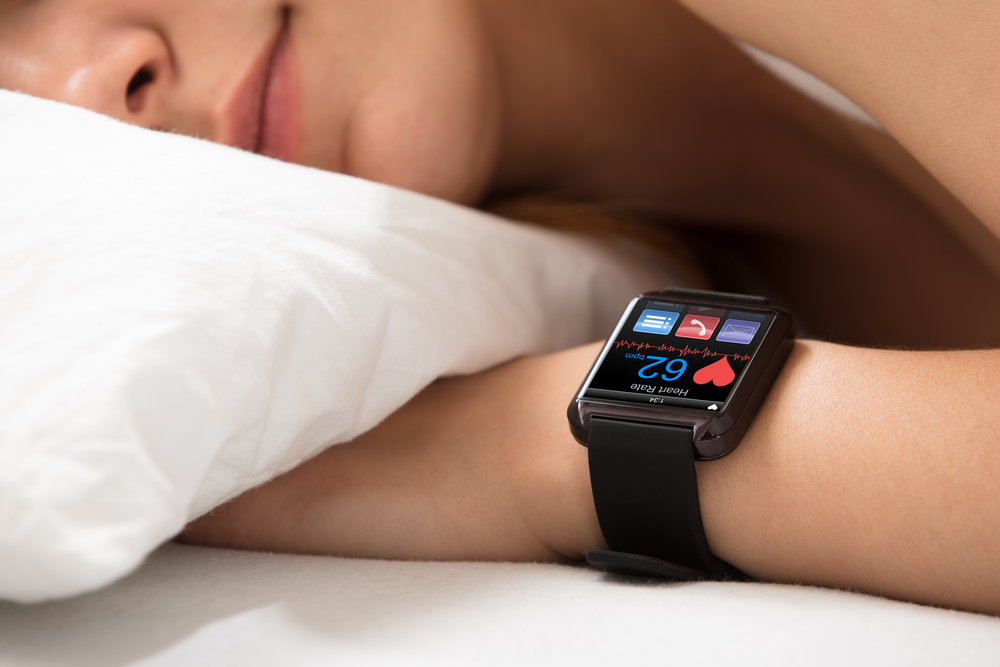 Smart,watch,showing,heartbeat,rate,on,sleeping,woman's,hand
