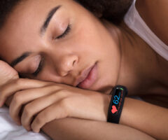 Close Up,of,smartwatch,showing,heartbeat,rate,on,sleeping,woman's,hand